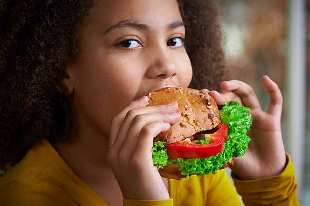istock Girl eating a healthy sandwich 481751597