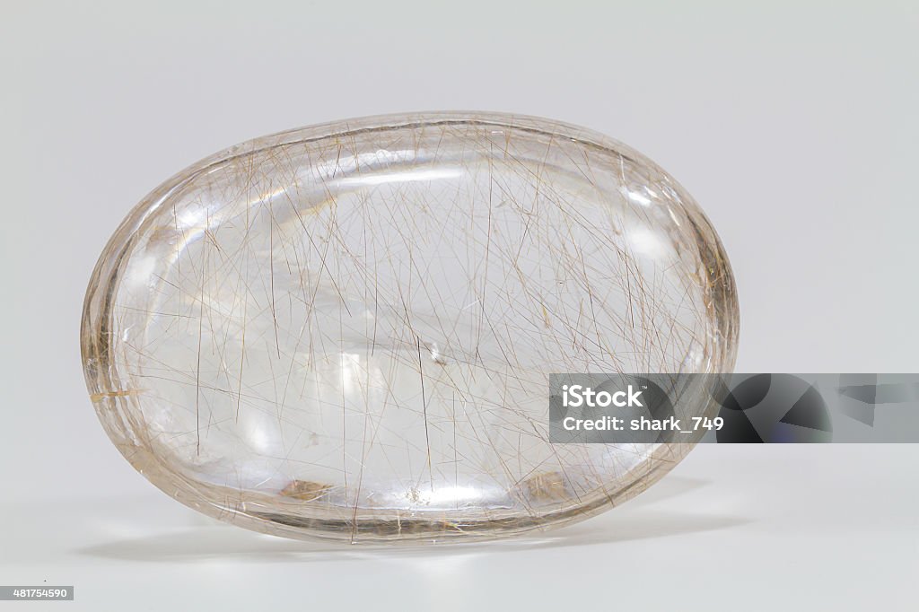 Crystal stone with silver and bronze thread on white background Crystal stone with silver and bronze thread inside 2015 Stock Photo