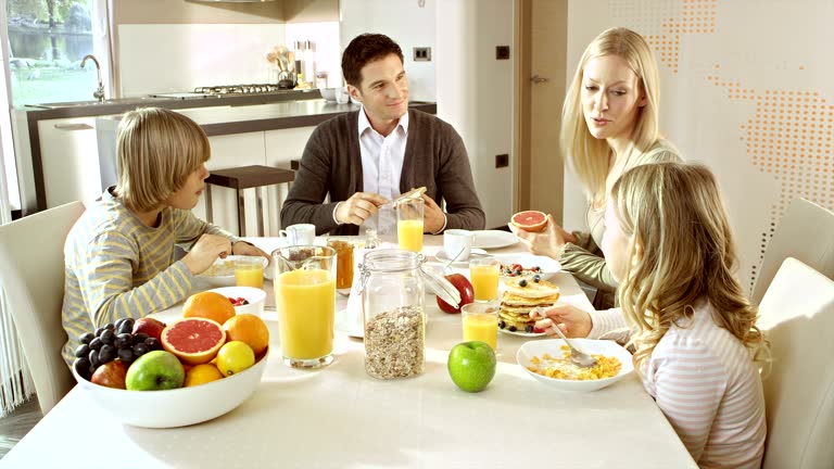 Family eating breakfast at a nicely set table