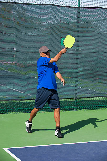 istock Pickleball Action - Man Following Through After Serving Ball 481754744