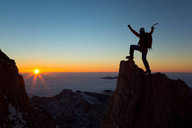istock Hiker standing on mountain peak and celebrating 481754868
