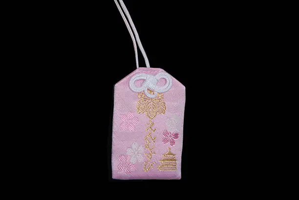 Omamori is a japanese charm, amulet or talisman. This one is from the famous Kinkakuji temple. It is said that this one brings luck in love to its owner.