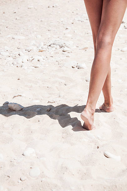 istock Slim legs with on the sand 481756116