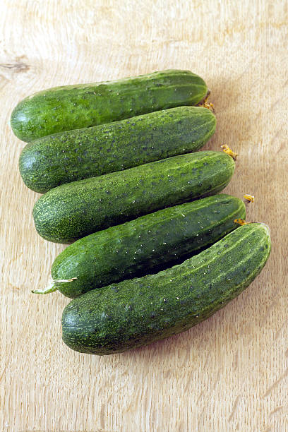 istock Row of five cucumbers closeup 481760668