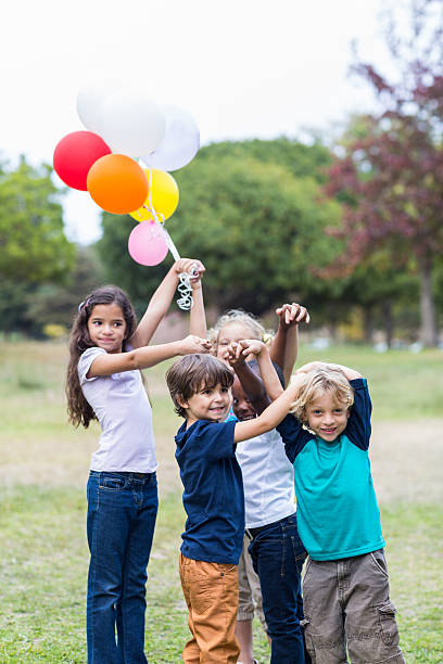 istock Happy children holding balloons 481761140