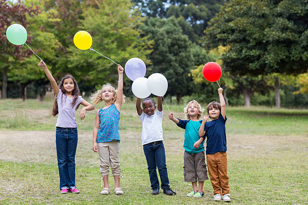 istock Happy children holding balloons 481761186
