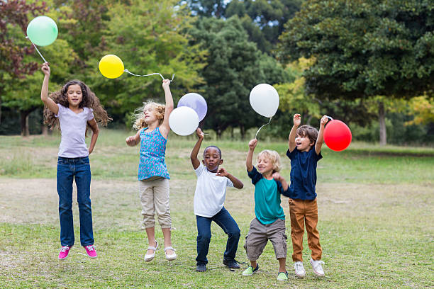 istock Happy children holding balloons 481761236