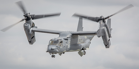 Fairford, UK - July 18, 2015: A V-22 Osprey tilt-rotor transport aircraft operated by the US Air Force in flight over Gloucestershire, England. 