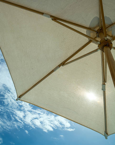 istock parasol on a background of blue sky with clouds 481762014