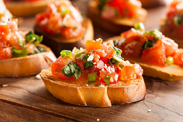 Homemade Italian Bruschetta Appetizer Homemade Italian Bruschetta Appetizer with Basil and Tomatoes antipasto stock pictures, royalty-free photos & images