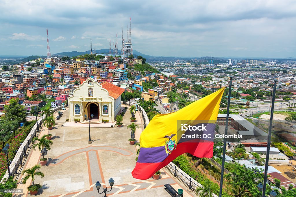 Flag and Church in Guayaquil Ecuadorian flag on top of Santa Ana hill with a church and the city of Guayaquil visible in the background in Ecuador Ecuador Stock Photo