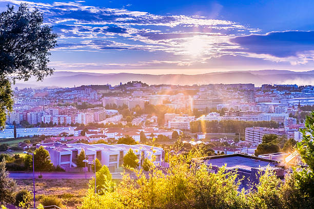 Braga city sunset flare cityscape Braga city sunset panorama seen from the east. Braga is a city in the northern part of Portugal, founded by the Romans as Bracara Augusta, with over 2000 years of history and in constant development, growth and expansion. The original city is seen towards the centre. braga portugal stock pictures, royalty-free photos & images
