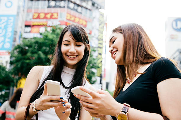 istock Young women using their smart phones, retail district 481767420