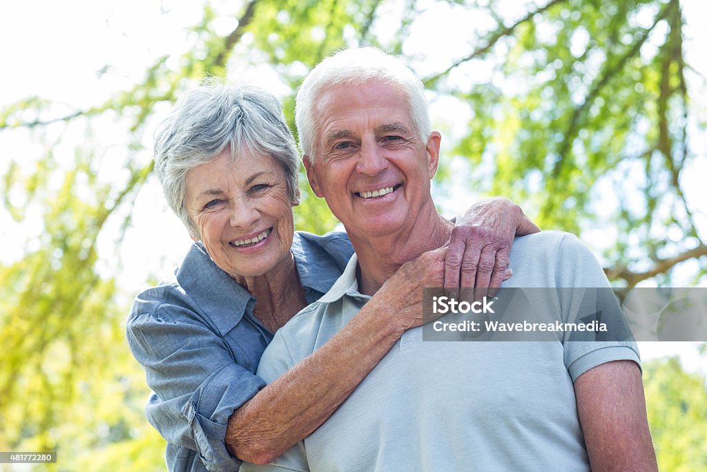 Happy old couple smiling Happy old couple smiling in a park on a sunny day  Active Seniors Stock Photo