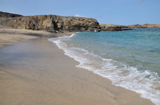 Gentle waves romance the white sand beach found on the uninhabited islet of Djeu part of the archipelago of Cabo Verde