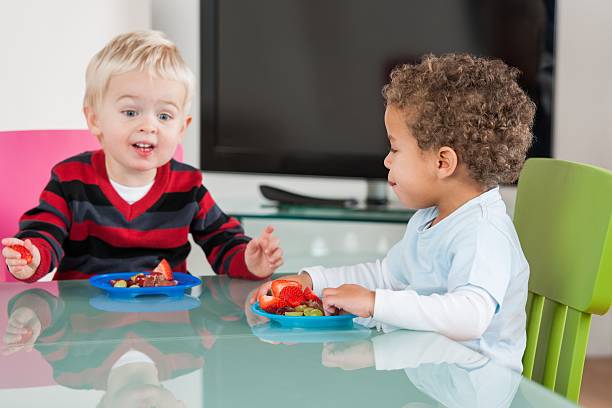 istock Little Boys Having Fruit In The Living Room 481774685