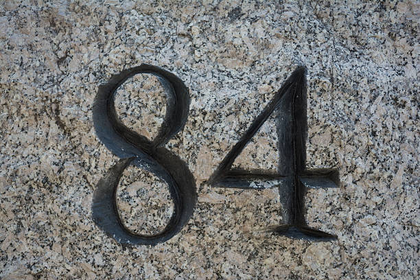 istock Number 84 for pier etched in a stone 481775228