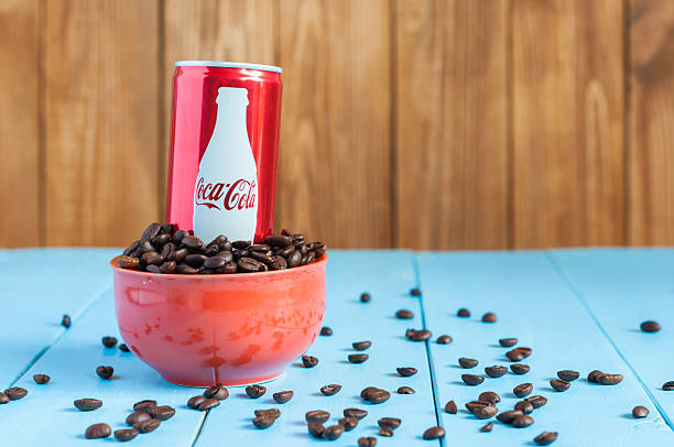 KIEV, UKRAINE - MAY 8, 2015: Can Coca-cola with coffee. Kiev, Ukraine May 8, 2015. Coca-Cola in bowl with coffee. Unhealthy food and drinks coke zero photos stock pictures, royalty-free photos & images