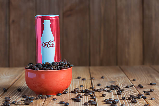 KIEV, UKRAINE - MAY 8, 2015: Can Coca-cola with coffee. Kiev, Ukraine May 8, 2015. Coca-Cola in bowl with coffee. Unhealthy food and drinks coke zero photos stock pictures, royalty-free photos & images