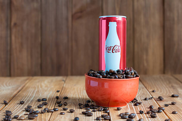 KIEV, UKRAINE - MAY 8, 2015: Can Coca-cola with coffee. Kiev, Ukraine May 8, 2015. Coca-Cola in bowl with coffee. Unhealthy food and drinks coke zero photos stock pictures, royalty-free photos & images