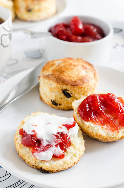 Scones with raisins, served with strawberry jam and cream