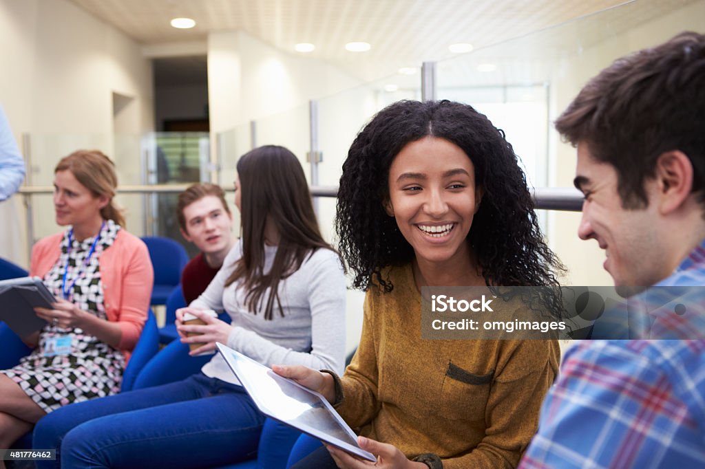 College Students Having Informal Meeting With Tutors Meeting Stock Photo