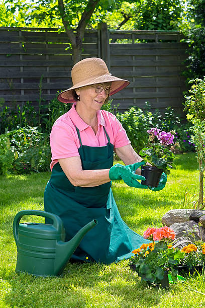 istock Woman admiring a potted plant. 481780874