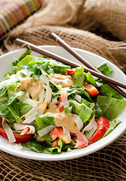 istock Thai salad with rice noodles, spinach and peanut sauce 481784384