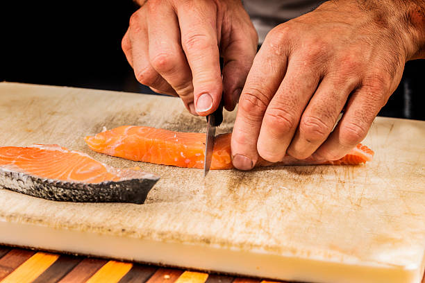 istock fishmonger prepares a salmon fillet 481785242