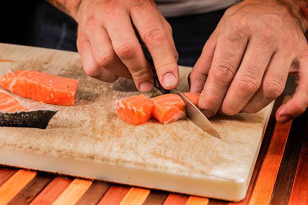 istock fishmonger prepares a salmon fillet 481785246