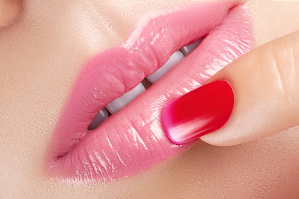 istock Red lag polish and pink lips. 481786288