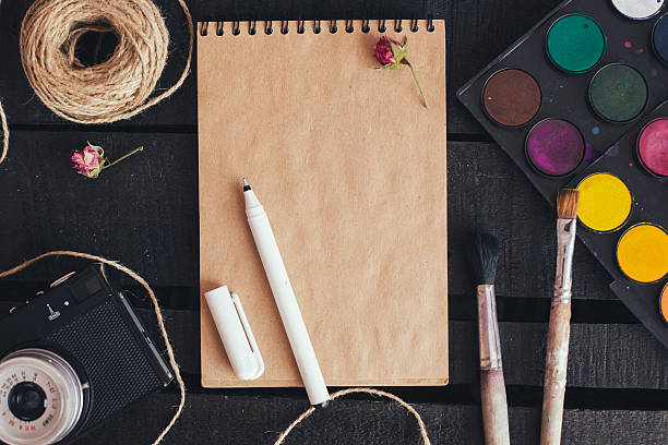 istock Blank paper mockup with artist brushes on wooden table 481788010