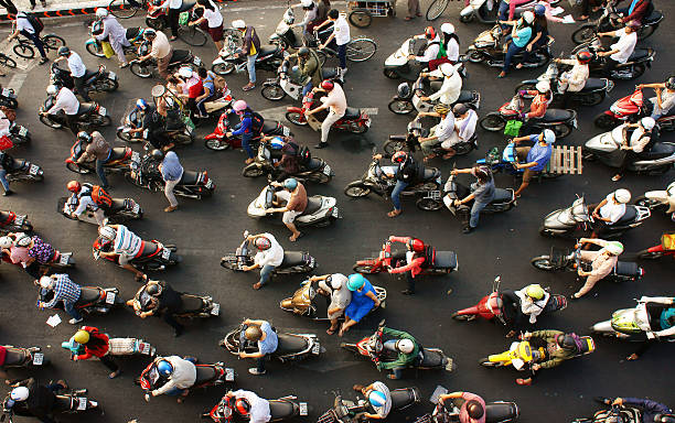 Ho chi Minh city, Viet Nam- March 27, 2014: Dense, crowed  scene of city traffic  in rush hour, crowd of people wear helmet, transport by motorcycles, stop at red light in stress situation, Vietnam, Mar 27, 2014