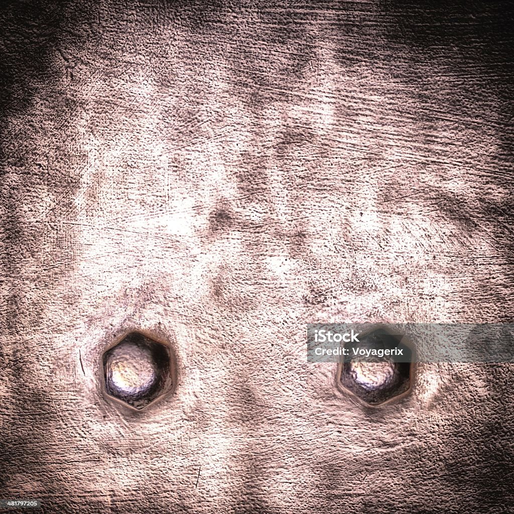 Grunge red claret metal plate rivets screws background texture Closeup of grunge red claret metal plate with rivets and screws as background or texture. Square format. Backgrounds Stock Photo