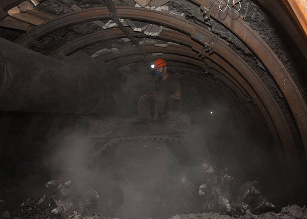 Miner Donetsk, Ukraine - March 14, 2014: he driver of the coal miner working in a cloud of dust in the underground mine donets basin photos stock pictures, royalty-free photos & images