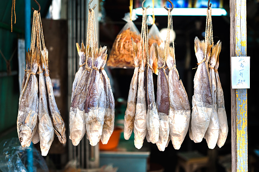 TAI O, HONG KONG - Salted fish are a favourite Hong Kong delicacy. Here, bunches of hanging fish dry in the sun at Tai O fishing village, Lantau Island.