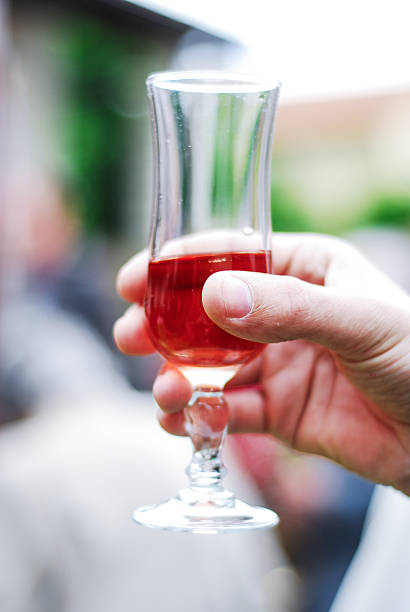 Hand holding up a glass of Rosé stock photo