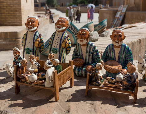 Many souvenirs are available for tourists in the ancient Silk Road city of Khiva, Uzbekistan. These depict old men in traditional dress.
