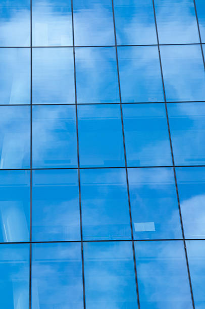 istock Reflection of blue sky on window glass office building 481806594