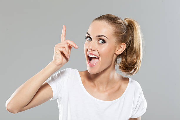 une el pelo rubio mujer joven señalando - arms raised pointing inspiration ideas fotografías e imágenes de stock