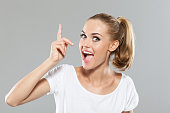 Excited blond hair young woman pointing