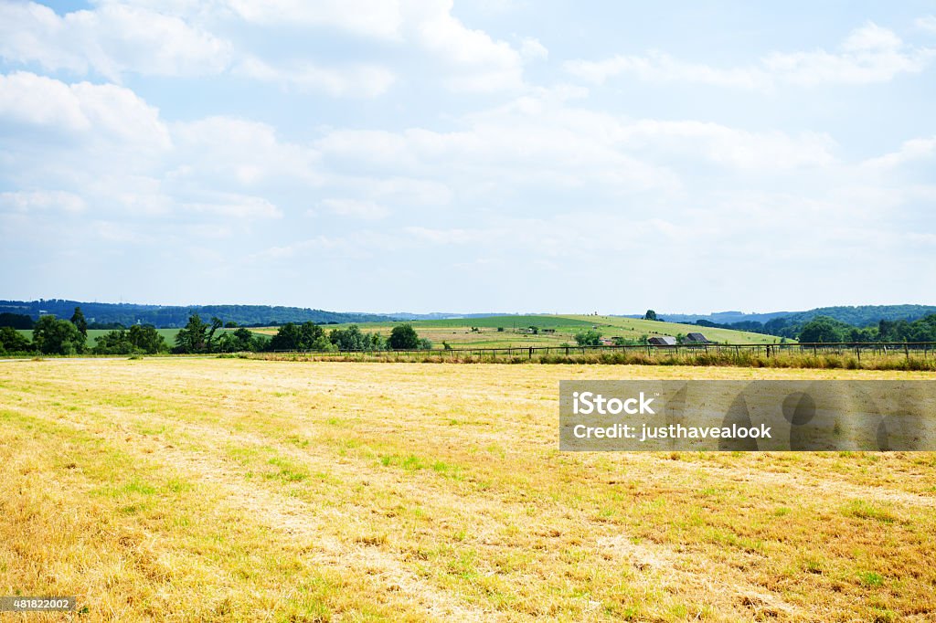 Harvested field and valley Ruhr Harvested field and valley Ruhr in south of Essen at summertime. View from Meisenburg and road Schuir down into and over valley. Ruhrgebiet. 2015 Stock Photo