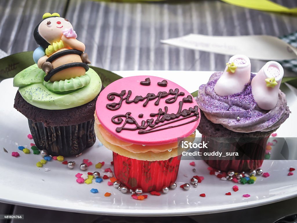 Birthday Cup Cake Decorated cup cake on a fancy plate 2015 Stock Photo