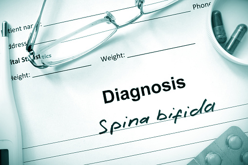 Diagnostic form with diagnosis Spina bifida and pills.