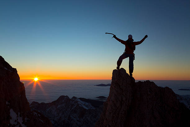 istock Hiker standing on mountain peak and celebrating 481826642