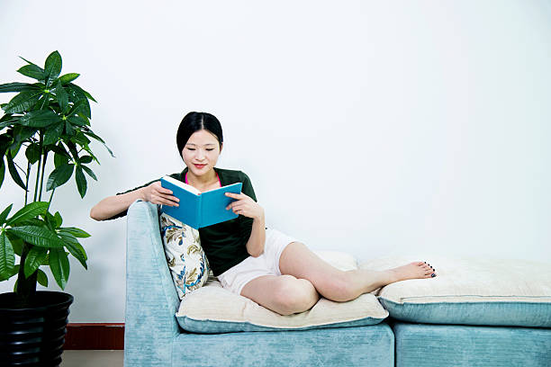 istock Reading book in living room 481827688