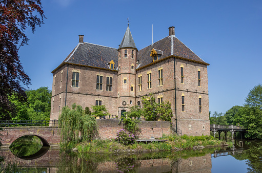 Vorden, The Netherlands - May 24, 2015: Castle of Vorden surrounded by a pond in Vorden, the Netherlands. The castle dates back to the 13th century.