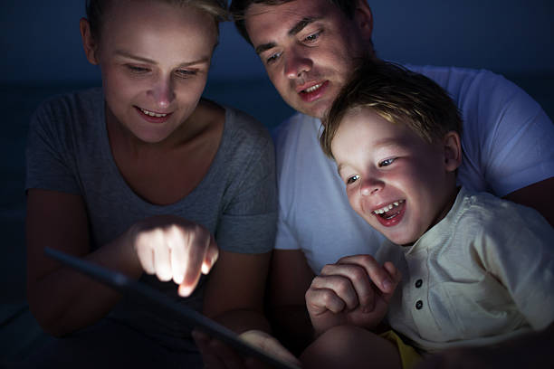 istock Parents and son with tablet PC outdoor late in the 481831018