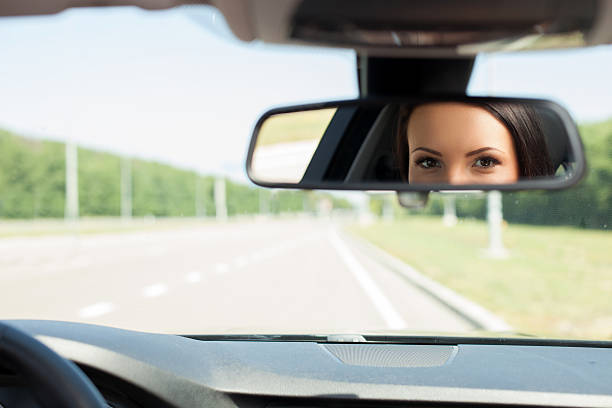 istock Cheerful young woman is driving her car 481832410