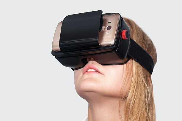 istock Young woman entertaining with VR-Helmet 481833370